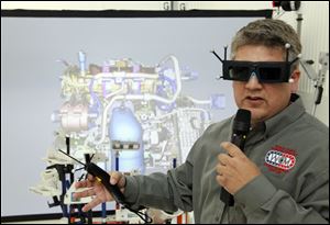 Tim Randolph, industrial engineering manager, wears a pair of 3D glasses as he demonstrates a 3D simulator during a tour of Chrysler's Toledo Assembly complex on Wednesday.