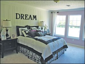 A second master bedroom has hand-fitted paneling to create a faux headboard.