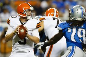 Detroit defensive end Willie Young, right, puts pressure on Cleveland's Brandon Weeden during the first quarter on Friday.