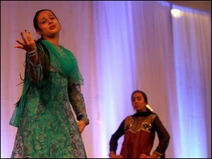 (left to right) Sumiran Shah and Kimi Shah perform an Indian Fusion dance at the Festival of India held at the Hindu Temple of Toledo in Sylvania in August 2011. The festival showcased dance performances as well as food and jewelry and clothing for sale.