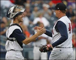 Hens catcher Brad Davis, left, congratulates pitcher Zach Miner after the Hens closed out Game 1.

