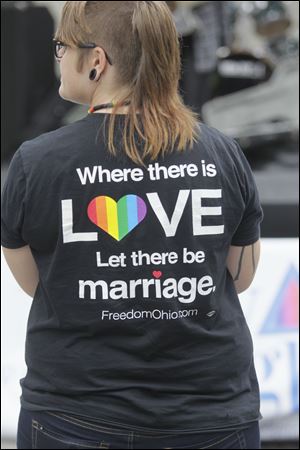 A parade-goer wears a T-shirt with an advocacy message. Seven couples participated in a commitment ceremony at Saturday's event downtown. 