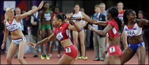 American DeeDee Trotter, second from right, hands the baton to Allyson Felix during the 4x400-meter relay Saturday in London. The United States won by a whopping 3.36 seconds over Russia.