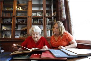 Lolabel Lathrop of Holland, left, and her youngest daughter, Billie
Szczepanski of Archbold, Ohio, look over yearbooks during the festival. Ms. Lathrop was a freshman at Monclova School in 1949.