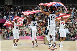 Team mates Chris Paul (13), James Harden (12), Anthony Davis (14), and Russell Westbrook (7) celebrate winning the men's basketball gold medal game between the United States and Spain on Day 16 of the London 2012 Olympics