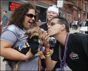 Rebecca Facey, left, and her partner, Angie Carriker, center, show their dog, Chompers, to Michael Ladriere of My House Diner. Mr. Ladriere was announcing a weekend discount at the restaurant.