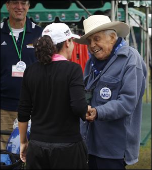Lincoln Martin, 100, greets his granddaughter, Mo, on Saturday. He goes to most tour stops.