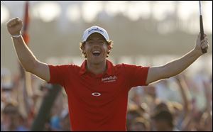 Rory McIlroy celebrates after sinking a final putt to wrap up the PGA Championship, which he won by a record eight strokes.