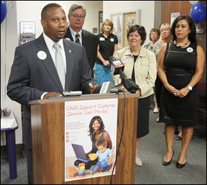 Michael Colbert, Ohio Department of Job and Family Services chief, addresses the news conference. Behind him are Commissioners Pete Gerken and Tina Skeldon Wozniak, and agency director Deb Ortiz-Flores.