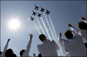 A formation of U.S. Navy Blue Angel fighter jets perform a flyover above graduating Midshipmen during the United States Naval Academy graduation and commissioning ceremonies May 29 in Annapolis, Md..