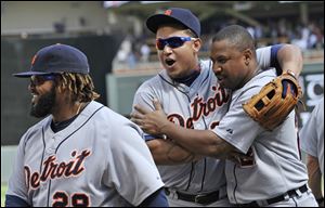 Detroit Tigers' Miguel Cabrera, center, and Delmond Young, right, celebrate the Tigers' 5-1 win over the Minnesota Twins  in a baseball game Wednesday.