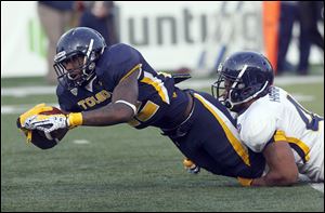David Fluellen plows through the defense of Dawalyn Harper during the University of Toledo Rockets' annual spring game. Last season Fluellen gained 493 yards in limited opportunities.