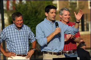 Vice Presidential candidate Rep Paul Ryan (R., Wis.), center, talks to supporters at a rally on the campus of Miami University in Oxford, Ohio Wednesday, as Ohio Gov. John Kasich, left, and Rep. Rob Portman listen.