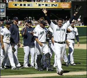 Seattle Mariners pitcher Felix Hernandez, front right, celebrates with teammates after tossing a perfect game in a 1-0 win over the Tampa Bay Rays.
