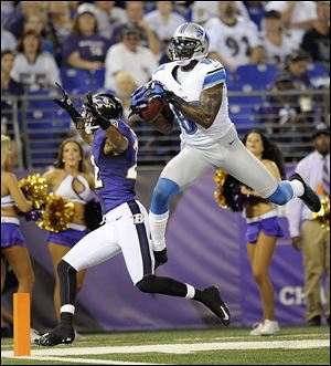 Detroit Lions wide receiver Calvin Johnson, right, scores a touchdown as Baltimore Ravens defensive back Jimmy Smith (22) runs past during the first half of Friday's preseason game.