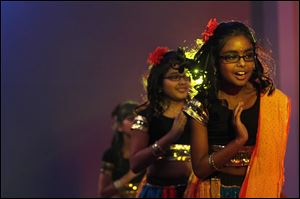 Anika Singhania, 11, of Sylvania, foreground, participates in a performance of a Bollywood dance with eight other girls. They were onstage Saturday at the 23rd Festival of India at the Hindu Temple and Heritage Hall in Sylvania Township.