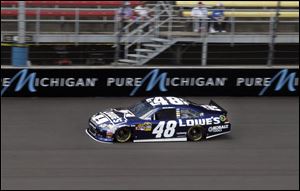 Jimmie Johnson takes a practice lap to qualify for the NASCAR Sprint Cup Series during the first day of the three-day NASCAR weekend at Michigan International Speedway.