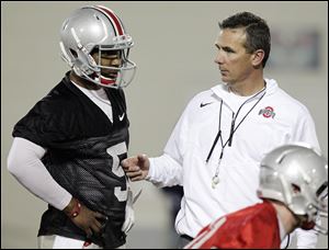 Urban Meyer, right, created his own spread offense in 2001 at Bowling Green, but the Ohio State coach has never been afraid of tweaking his own system.