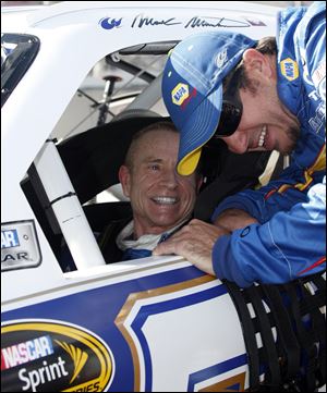 Mark Martin is congratulated by Martin Truex, Jr., after racing around MIS in a lap of 199.706 miles per hour on Friday.