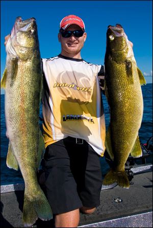 Toledo charter captain Ross Robertson holds a couple huge walleyes taken off Erie, Pa. Finding those walleyes can require a bit of research.