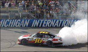 Greg Biffle celebrates with a burnout near the stands after winning on Sunday, taking the lead late in the race from Brad Keselowski.