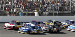 Greg Biffle, left, and Brad Keselowski lead the pack in the final laps at MIS. Biffle sprinted away in the end to win.