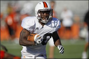 Bowling Green running back John Pettigrew ran for three touchdowns but it was a simple 1-yard run on a fourth-down play that earned him praise — not to mention a hug — from coach Dave Clawson.