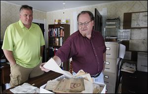 Ted Long, Sylvania Area Historical Society trustee, left, and Bob Smith, president, sift through documents at the Sylvania Heritage Center Museum. The house was once owned by Dr. Uriah Cooke and his family.