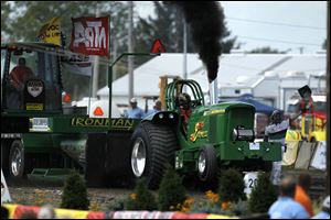 Jeremy Smith of Mednia, Ohio, races his John Deer tractor -- 