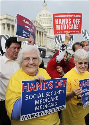 Sue Ward, left, of Upper Marlboro, Md., and a member of the National Committee to Preserve Social Security and Medicare, joins members of Congress and union members last year outside the Capitol to voice their opposition to potential cuts in Medicare, Medicaid, and Social Security benefits as Congress looks for ways to reduce government spending in all areas, on Capitol Hill in Washington.