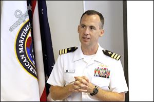 Cmdr. Josh Himes speaks to students from the Maritime Academy about Navy Week events. He complimented the academy's efforts.