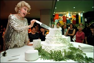 Phyllis Diller cuts the cake during the Goodwill Industries of Northwest Ohio's 65th birthday in 1998 in Toledo. She introduced herself as the 'Madonna of the Geritol Set.'