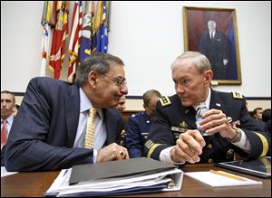 Defense Secretary Leon Panetta, left, and Joint Chiefs Chairman Gen. Martin Dempsey confer on Capitol Hill in Washington prior to testifying, in this April 19, 2012 file photo. Dempsey was not injured when militants fired rockets into a U.S. base in Afghanistan and damaged his plane on the ground.