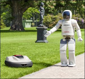 Honda Motor's Asimo, a walking talking robot, shows the company's new product lawn mower, Milmo.