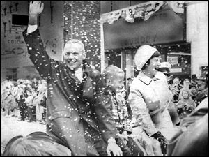 Astronaut Neil Armstrong waves as he receives a hero's welcome in his hometown of Wapakoneta, Ohio. The first man to step on the moon is showered by confetti and he and his wife Jan and son Eric ride in the parade.