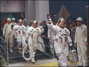In this July 16, 1969 file photo, Neil Armstrong waving in front, heads for the van that will take the crew to the rocket for launch to the moon at Kennedy Space Center in Merritt Island, Florida.  The family of Neil Armstrong, the first man to walk on the moon, says he has died at age 82. A statement from the family says he died following complications resulting from cardiovascular procedures. It doesn't say where he died. Armstrong commanded the Apollo 11 spacecraft that landed on the moon July 20, 1969. He radioed back to Earth the historic news of 