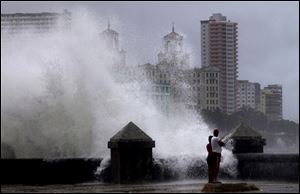 Waves pound the boardwalk, the Malecon, during the passing of Tropical Storm Isaac on Sunday in Havana, Cuba. The hurricane center said the storm, which was swirling north of the central coast of Cuba in the pre-dawn hours, was expected to be near or over the Florida Keys sometime later Sunday or Sunday night.