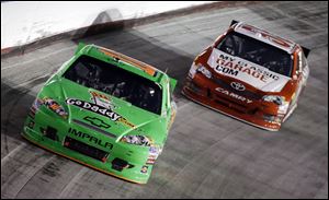 Danica Patrick (10) drives in front of Brian Vickers (55) during the NASCAR Sprint Cup Series auto race .