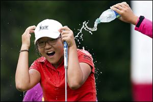 Lydia Ko, 15, is doused by fellow golfers after winning the LPGA Tour's Canadian Women's Open on Sunday. She became the youngest winner in LPGA Tour history.