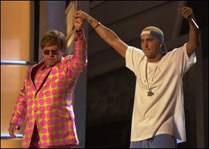 Elton John, left, and Eminem appear together after performing a duet near the end of the 43rd annual Grammy Awards in 2001 at the Staples Center in Los Angeles. Anti-gay sentiments have been entrenched in hip-hop for decades. Eminem, widely known for offensive lyrics toward homosexuals, has joined Jay-Z in saying people of the same-sex should be able to love one another.