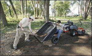 Nathan Seger, 17, left, and Andrew Bentley, 16, of the National Battlefield Park Youth Conservation Corps prepare for the event.