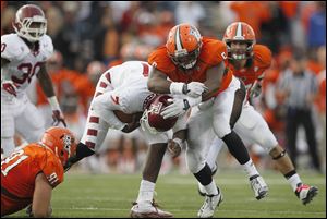 Falcons' defensive tackle Chris Jones, center, sacks Temple quarterback Chester Stewart during the 2011 game. Jones figures heavily into the BG defensive scheme this season, and he has drawn the attention of NFL scouts who have visited the BG campus this year. Jones is 6 feet, 1 inch tall, weighs 293 pounds, and owns several weight room records.