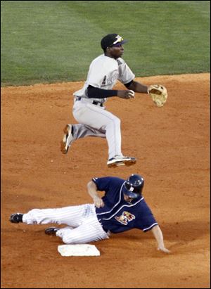 Louisville's Didi Gregorius goes high to avoid a sliding Ryan Raburn at second base Sunday in a game Toledo lost 4-3.