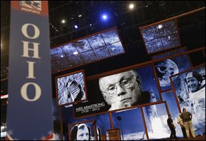 Behind the Ohio state delegate sign, pictures of Ohio native Neil Armstrong, the first man to walk on the moon, are displayed on the main stage the Republican National Convention in Tampa.