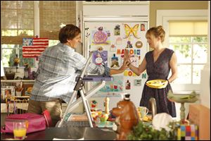 Nat Faxon, left, as Ben, and Dakota Johnson, as Kate, in a scene from 