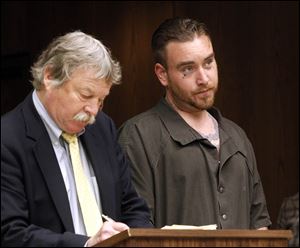 Public defender James MacHarg, left, stands beside Brandon Hoffman, 28, right, during his arraignment in the beating death of Scott Holzhauer, 47.