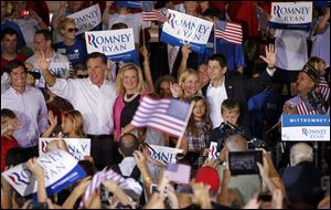 Republican presidential candidate Mitt Romney, with his wife Ann, and vice presidential running mate Paul Ryan, R-Wis., far right, and his wife, Janna, attend an Aug. 11 campaign rally in Manassas, Va.