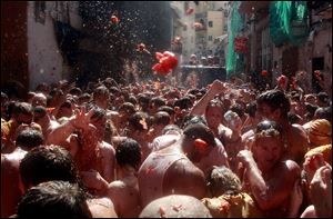 Revelers throw tomatoes during the annual 