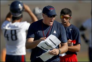 University of Arizona football coach Rich Rodriguez calling out to his players as they run drills during team practice in Sierra Vista, Ariz. 