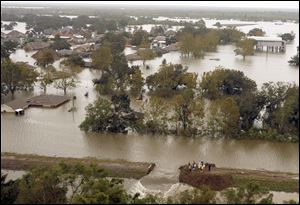 Flooding from an overtopped levee inundated the community of Braithwaite, La. with floodwaters from Hurricane Isaac. The levee break in the foreground was cut to relieve the flooding.